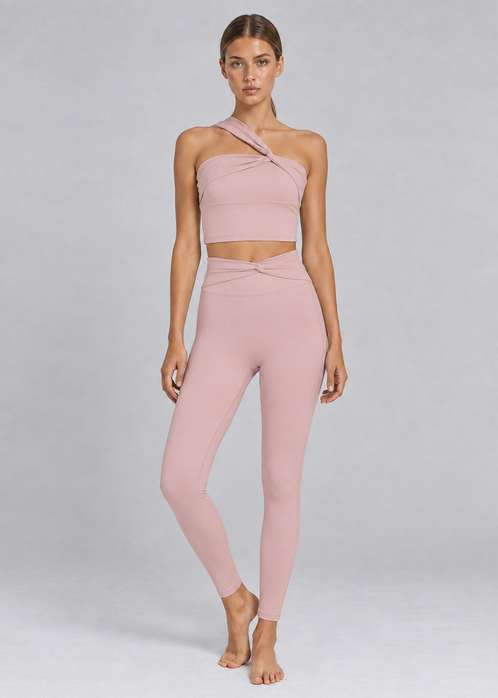 Blush pink one-shoulder crop top with crossover waist high-waisted leggings activewear set