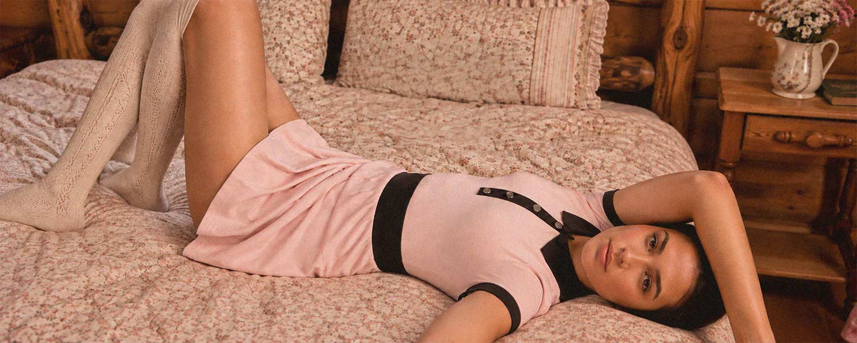 Flowglow pink contrast polo collar pleated tennis dress in a vintage bedroom setting