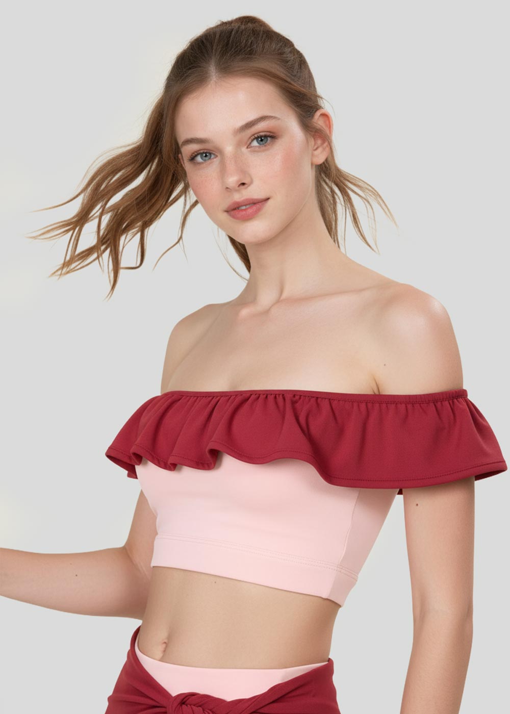 Women's blush pink off-shoulder ruffle crop top with burgundy contrast trim, front detail